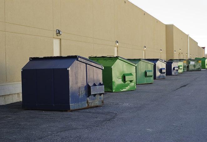 a group of construction workers taking a break near a dumpster in Atherton